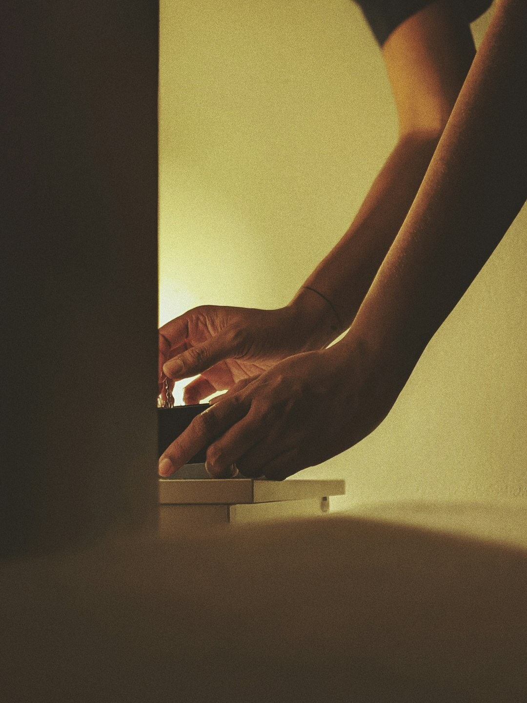 Person typing securely on a laptop in low light